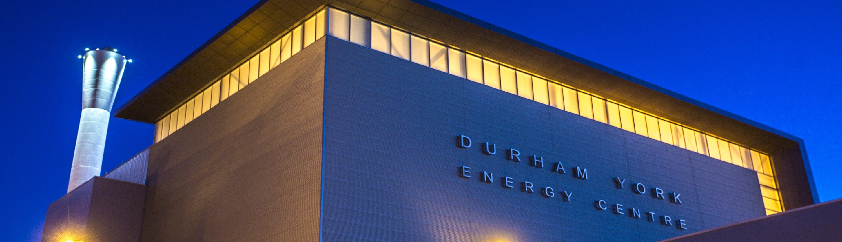 Night view of the Durham York Energy Centre sign on building